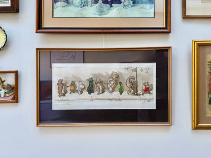 Framed vintage dog artwork on a wall with other framed items
